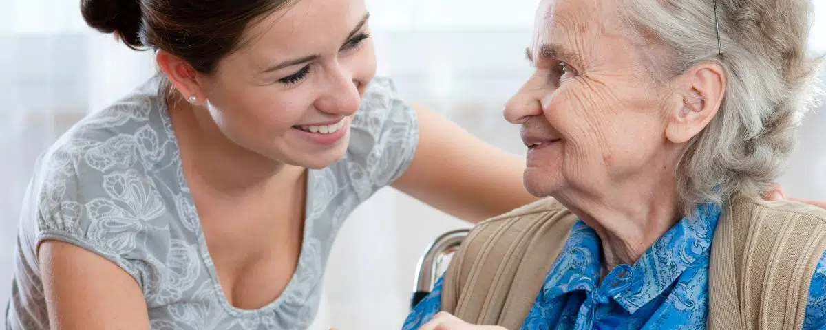 An elderly woman assisted by her personal home care attendant