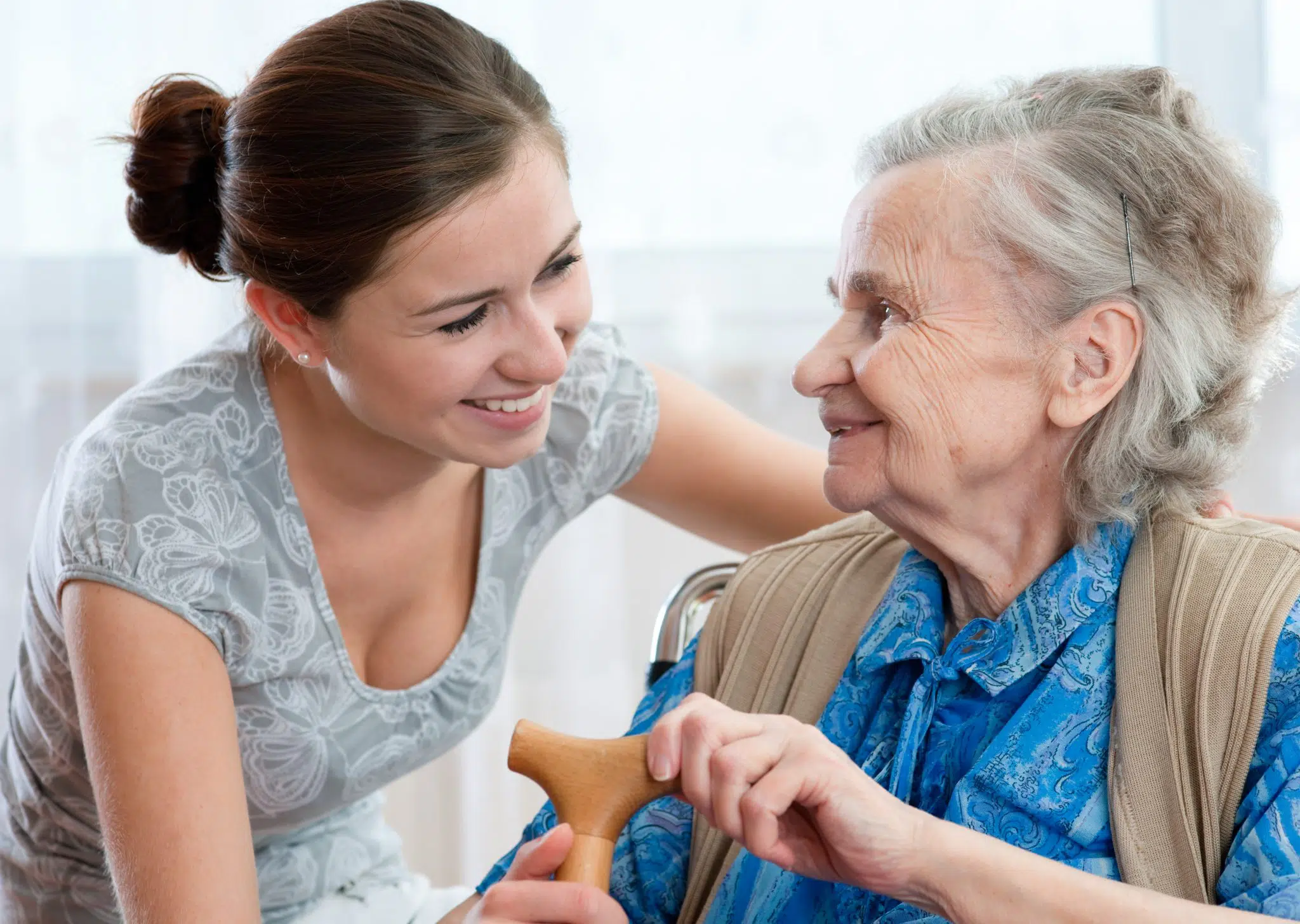 An elderly woman assisted by her personal home care attendant