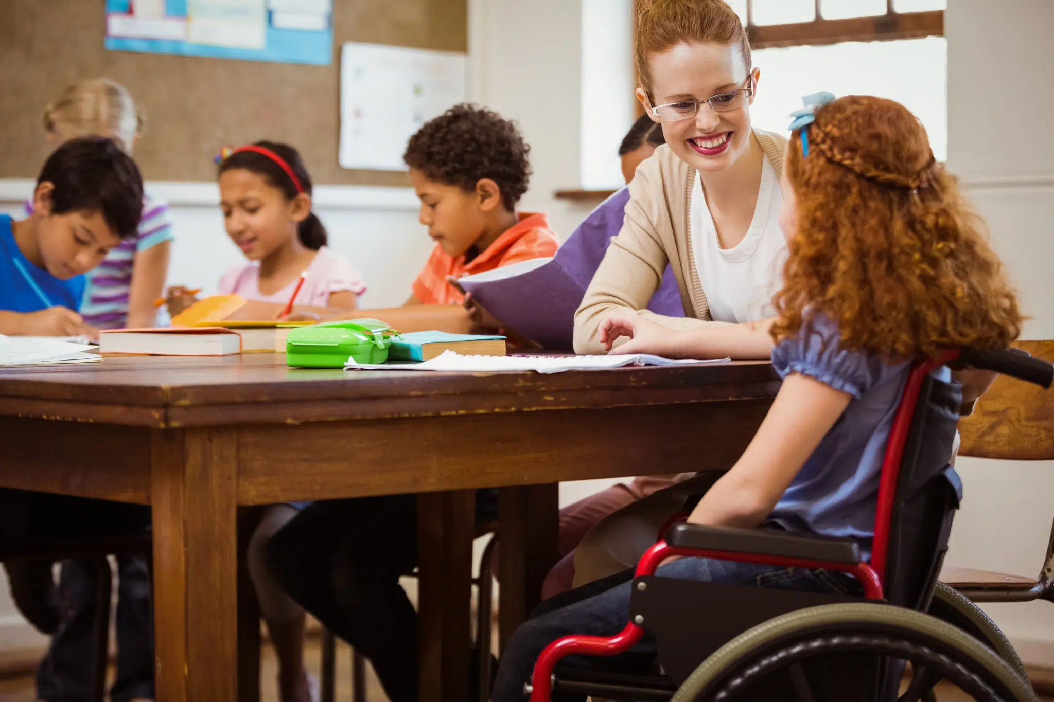 A teacher assists students in the classroom