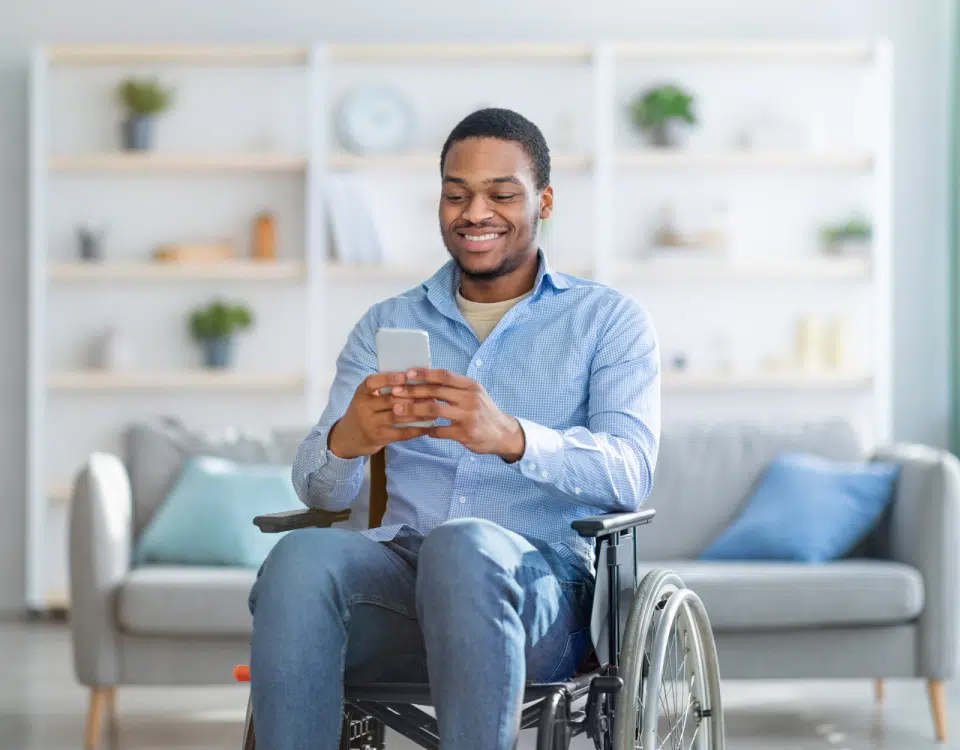 Man in Wheelchair on phone at home