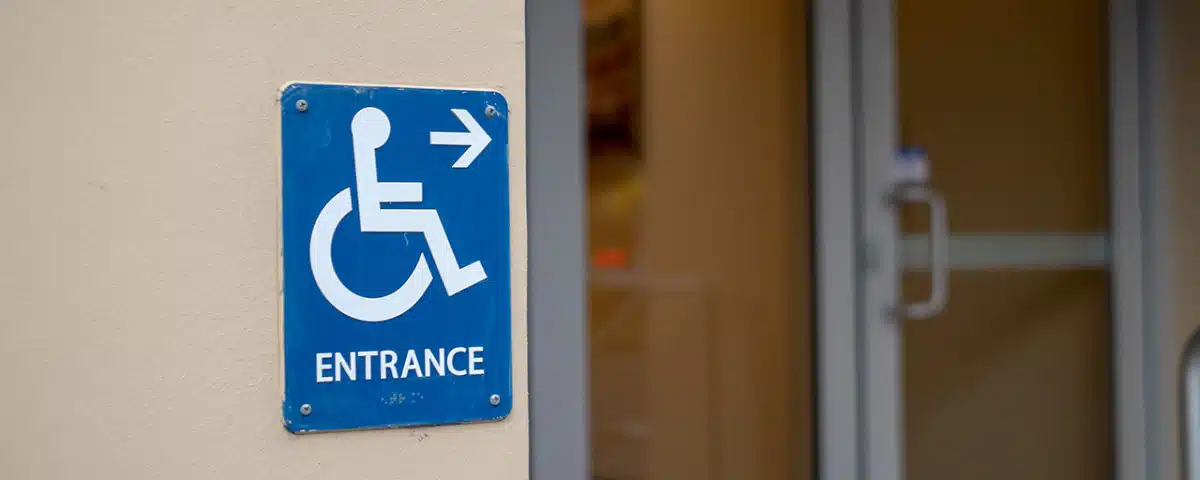 wheelchair entrance sign next to double doors