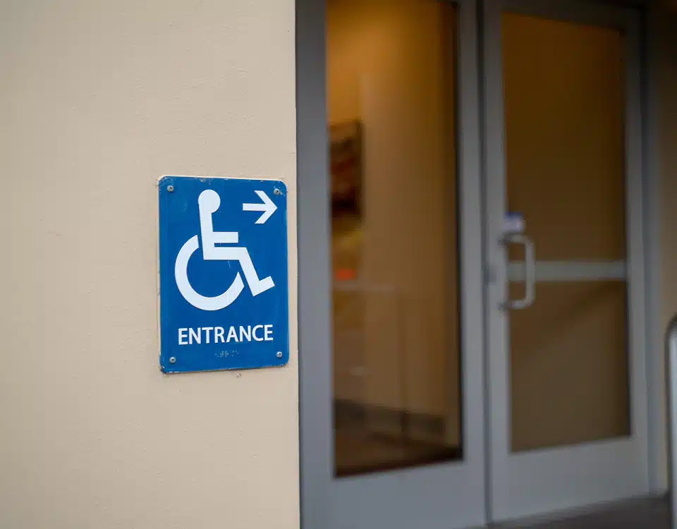 wheelchair entrance sign next to double doors
