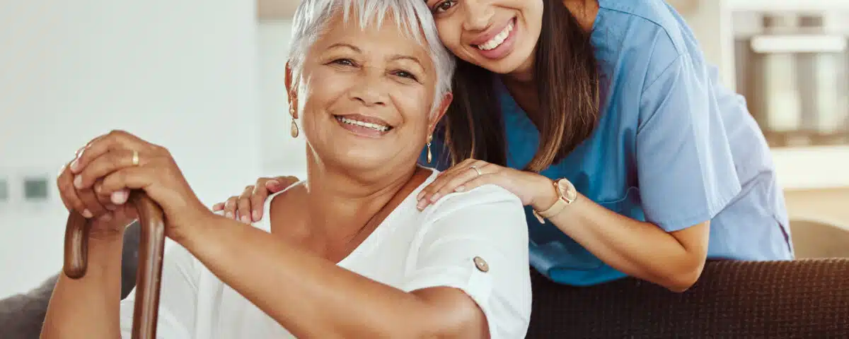 granddaughter hugging grandmother as personal care assistant