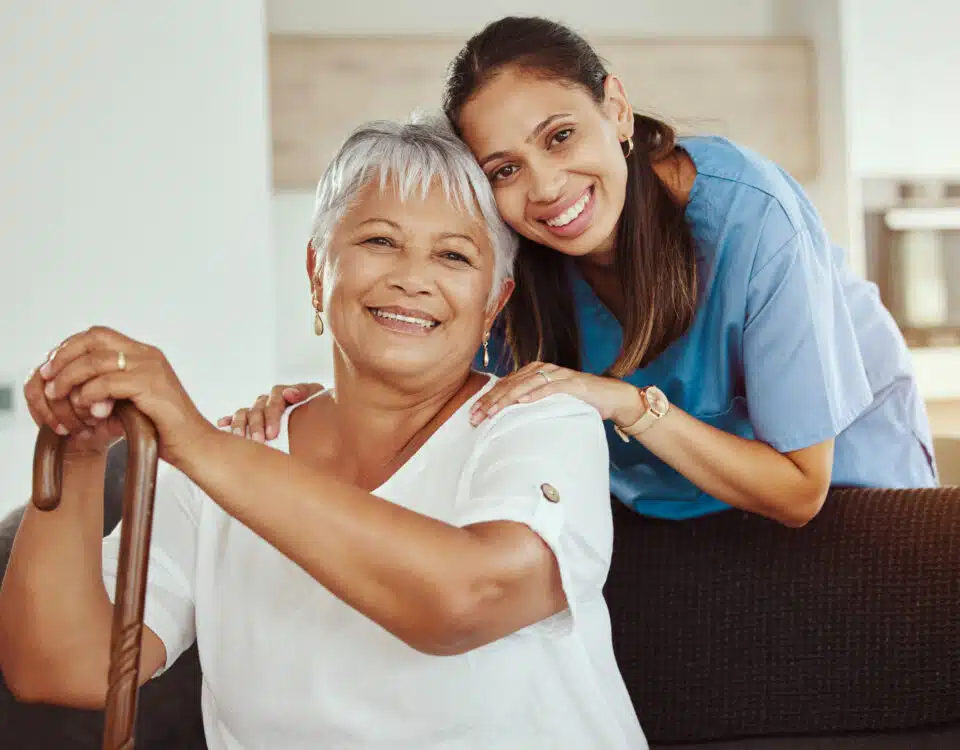 granddaughter hugging grandmother as personal care assistant