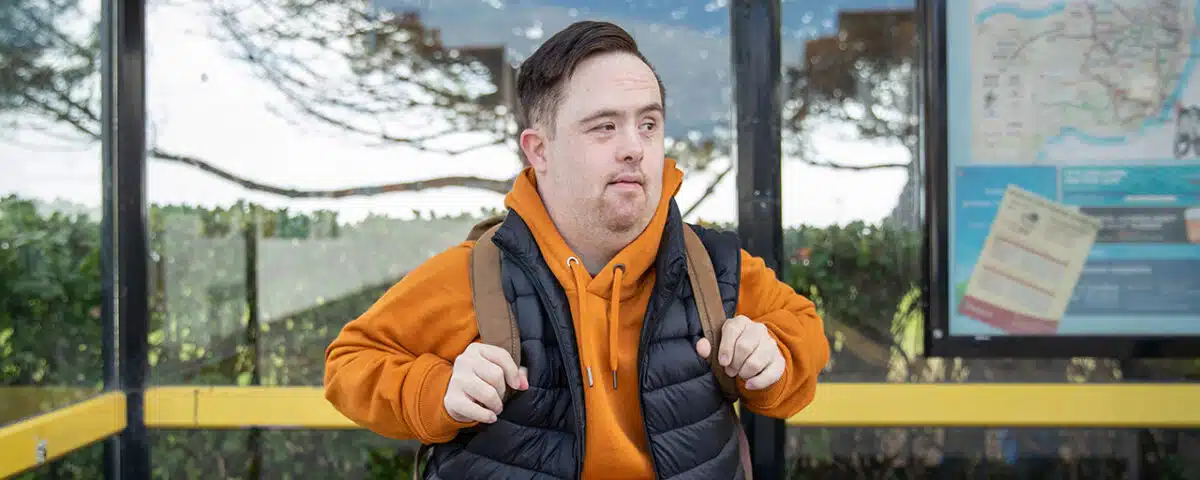 man waiting at bus stop