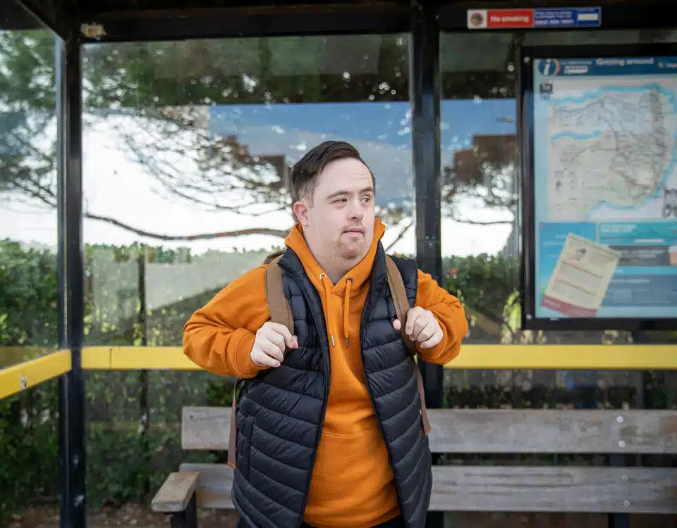 man waiting at bus stop